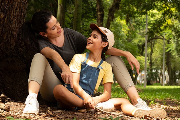 Girl with a tower in front of a mirror on a bathroom