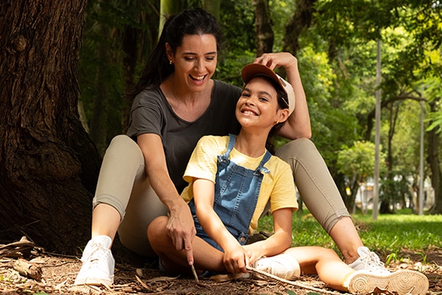 Girl with a tower in front of a mirror on a bathroom